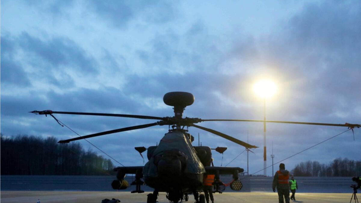 A U. Boeing AH-64 Apache attack helicopter is parked after landing at the Lielvarde military airbase in Lielvarde, Latvia. — AP