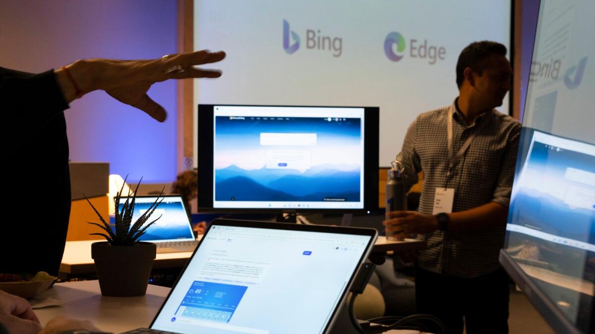 Computers show the new AI-powered Bing search engine during an introductory event at Microsoft's campus in Redmond, Washington. (Ruth Fremson/The New York Times)