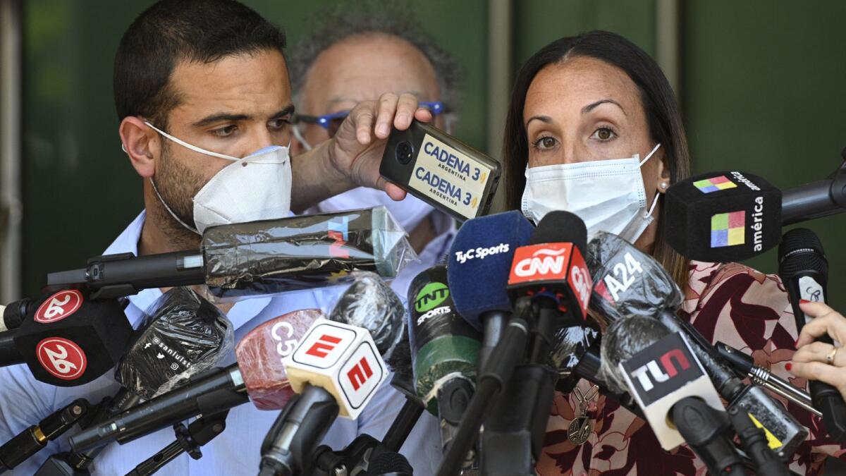 Therapists treating Argentina former football star Diego Maradona, psychiatrist Agustina Cosachov (right) and psychologist Carlos Diaz, talk to the media at the  clinic where Maradona underwent a brain surgery for a blood clot. Photo: AFP