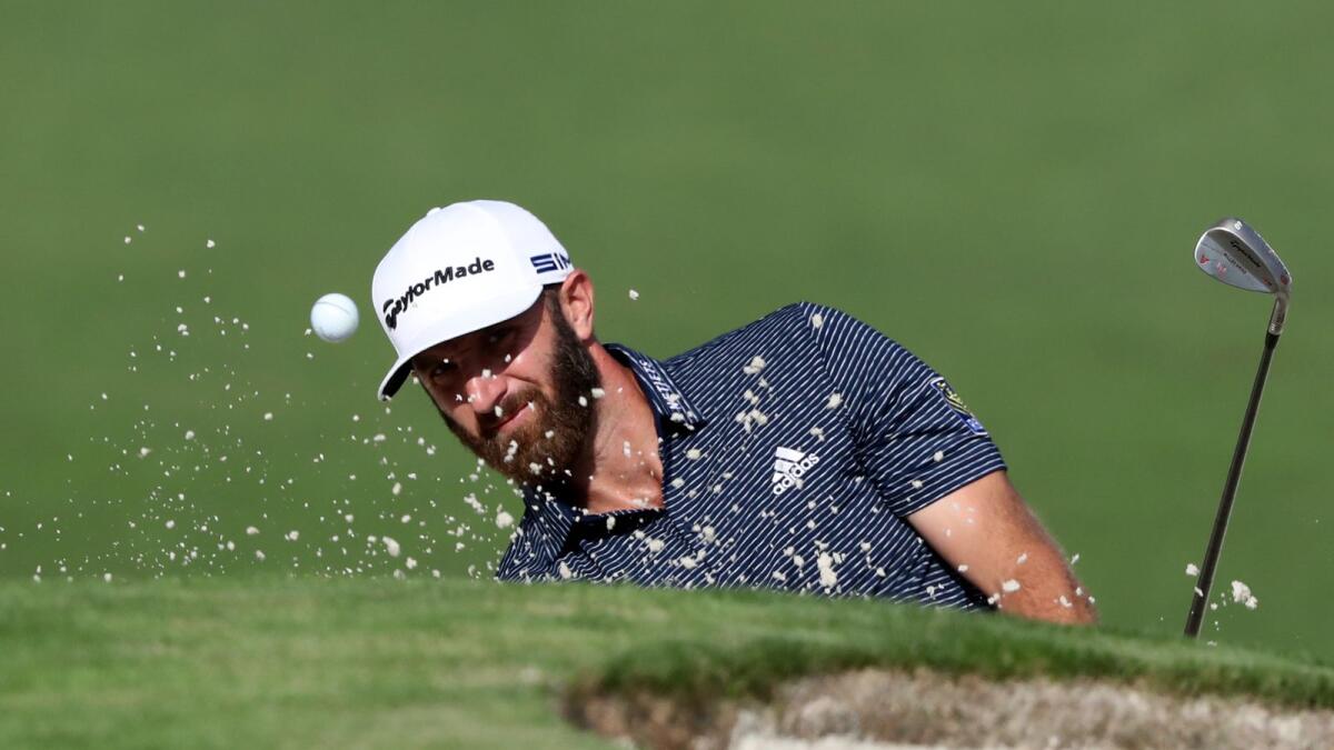 Dustin Johnson hits out of the bunker on the 2nd hole during the final round of the Masters. — AP