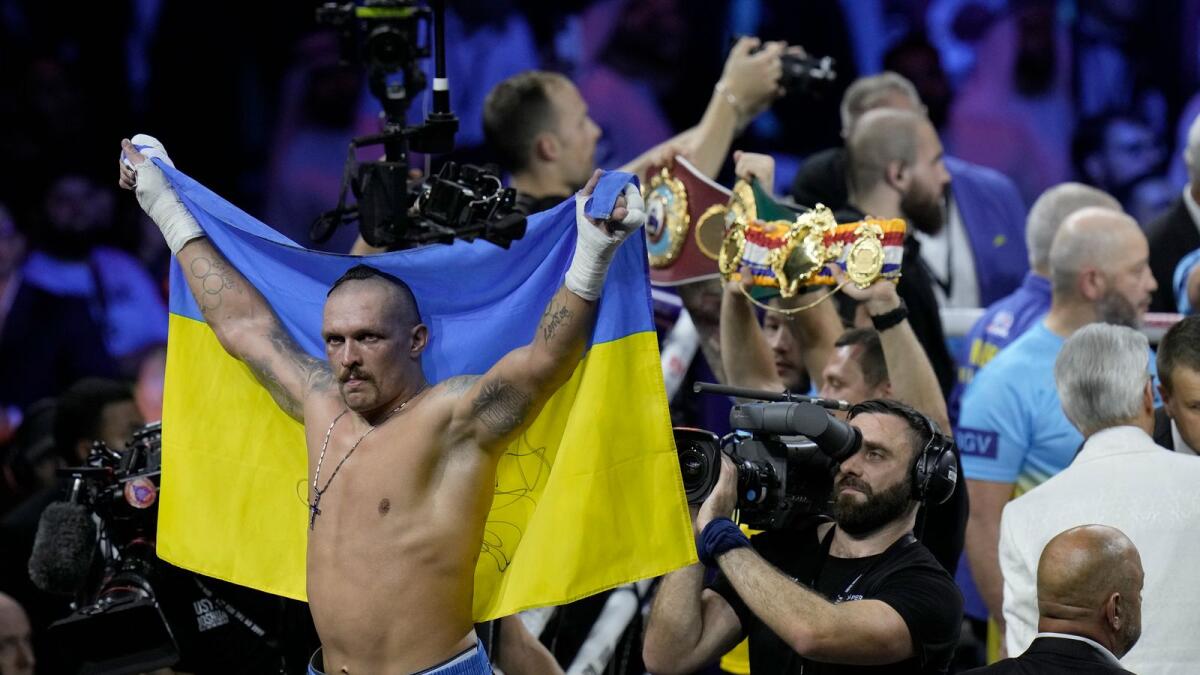 Ukraine's Oleksandr Usyk celebrates after beating Britain's Anthony Joshua to retain his world heavyweight title in Jeddah, Saudi Arabia. (AP)
