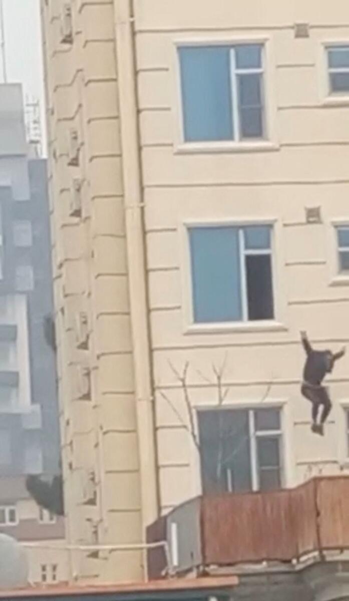 A person jumps from a hotel window. — Reuters