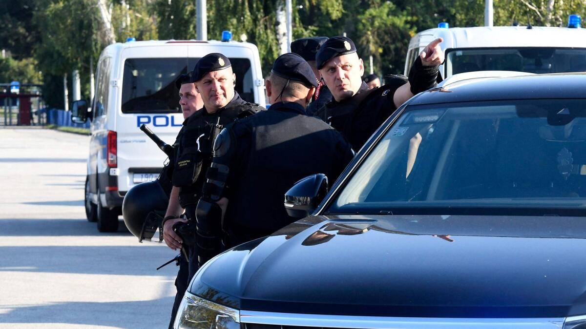 Greek police officers at a crime scene in Athens. - AFP file