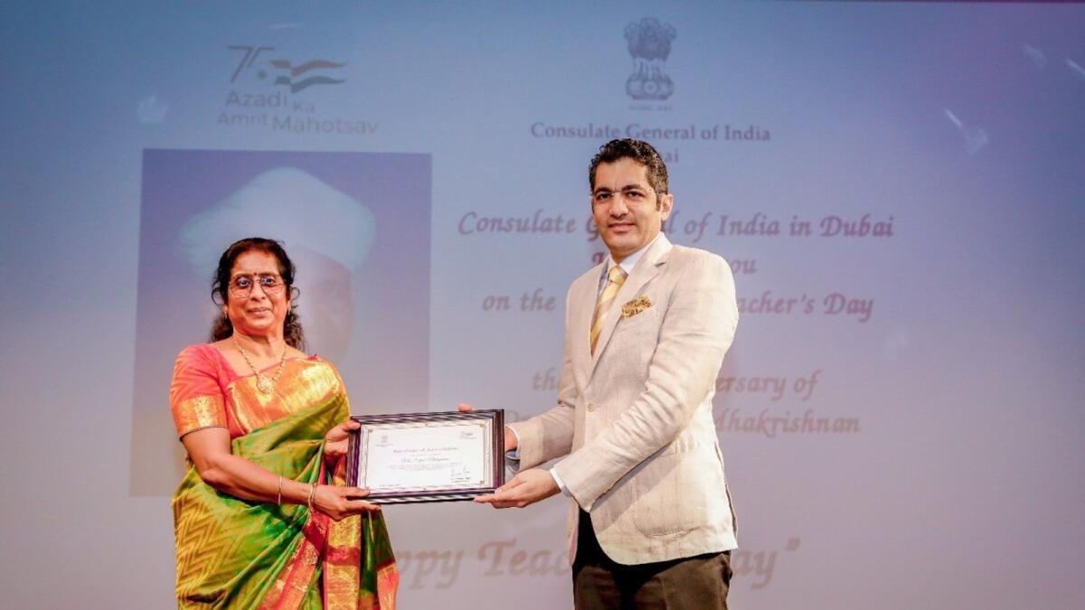 Sajini Narayanan Menon (left) honoured by the Consul General of India, Aman Puri, for being the longest-serving teacher. Supplied photos