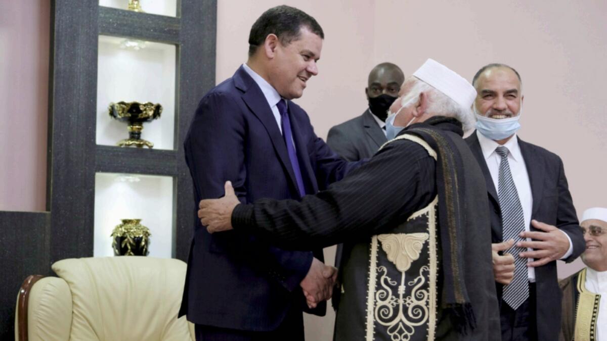 Libyan Prime Minister Abdul Hamid Dbeibeh meets community leaders after the parliament approved his interim government on Wednesday. — Reuters