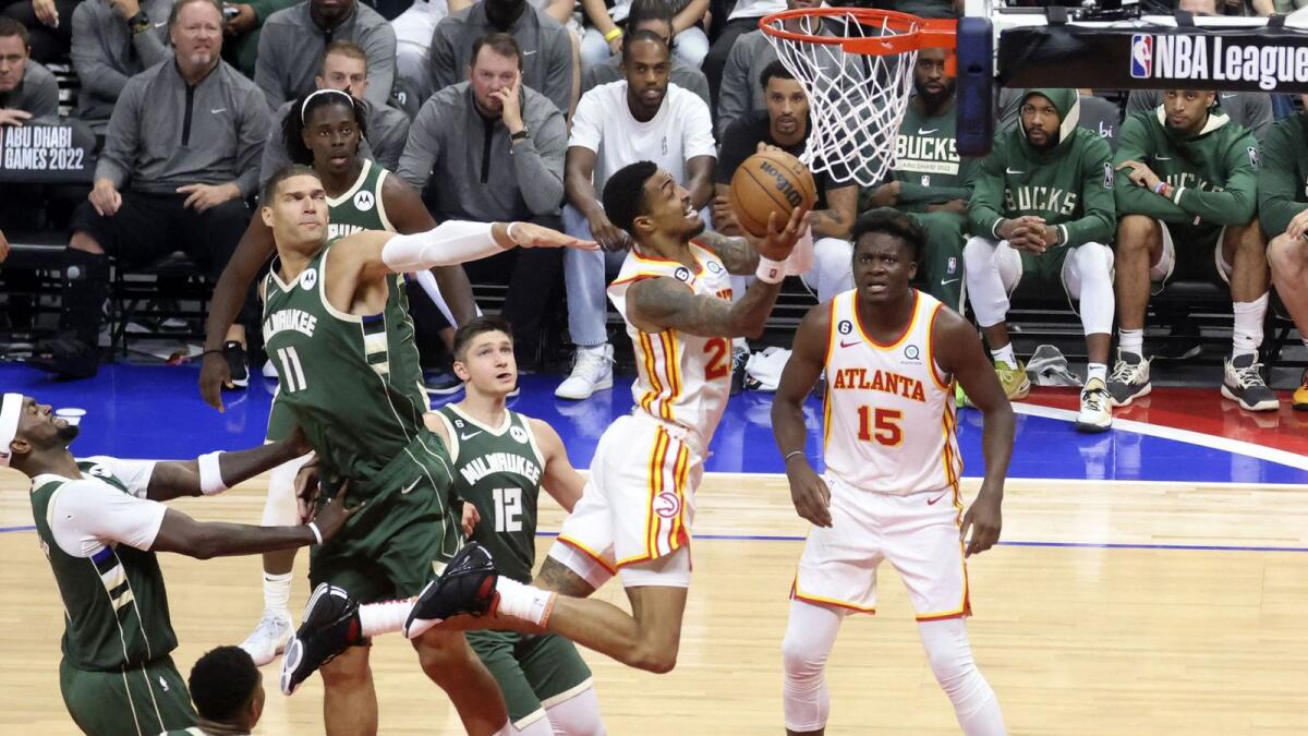 Atlanta Hawks forward John Collins (second from right) attempts a layup during the NBA pre-season basketball match against the Milwaukee Bucks at the Etihad Arena in Abu Dhabi on Thursday. — AFP