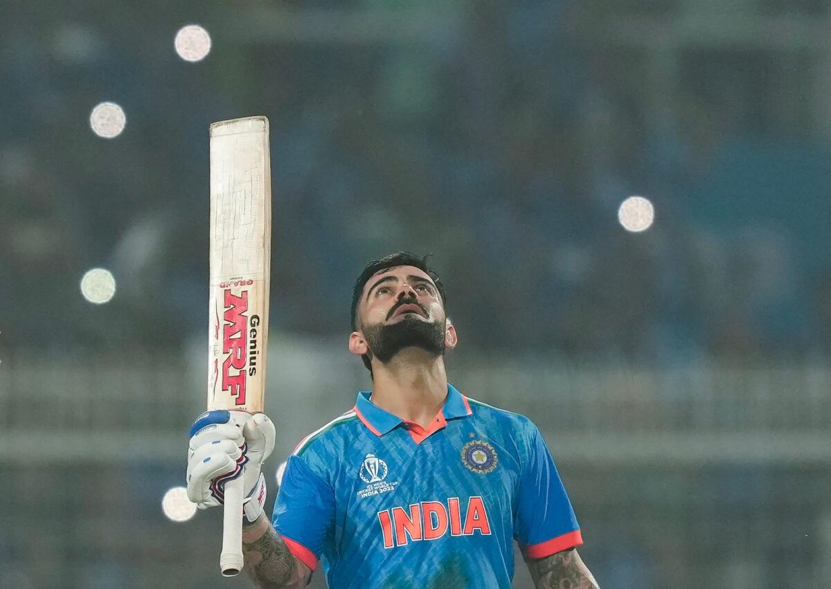 Indian batter Virat Kohli celebrates his record-equalling century during the World Cup match against South Africa. — PTI