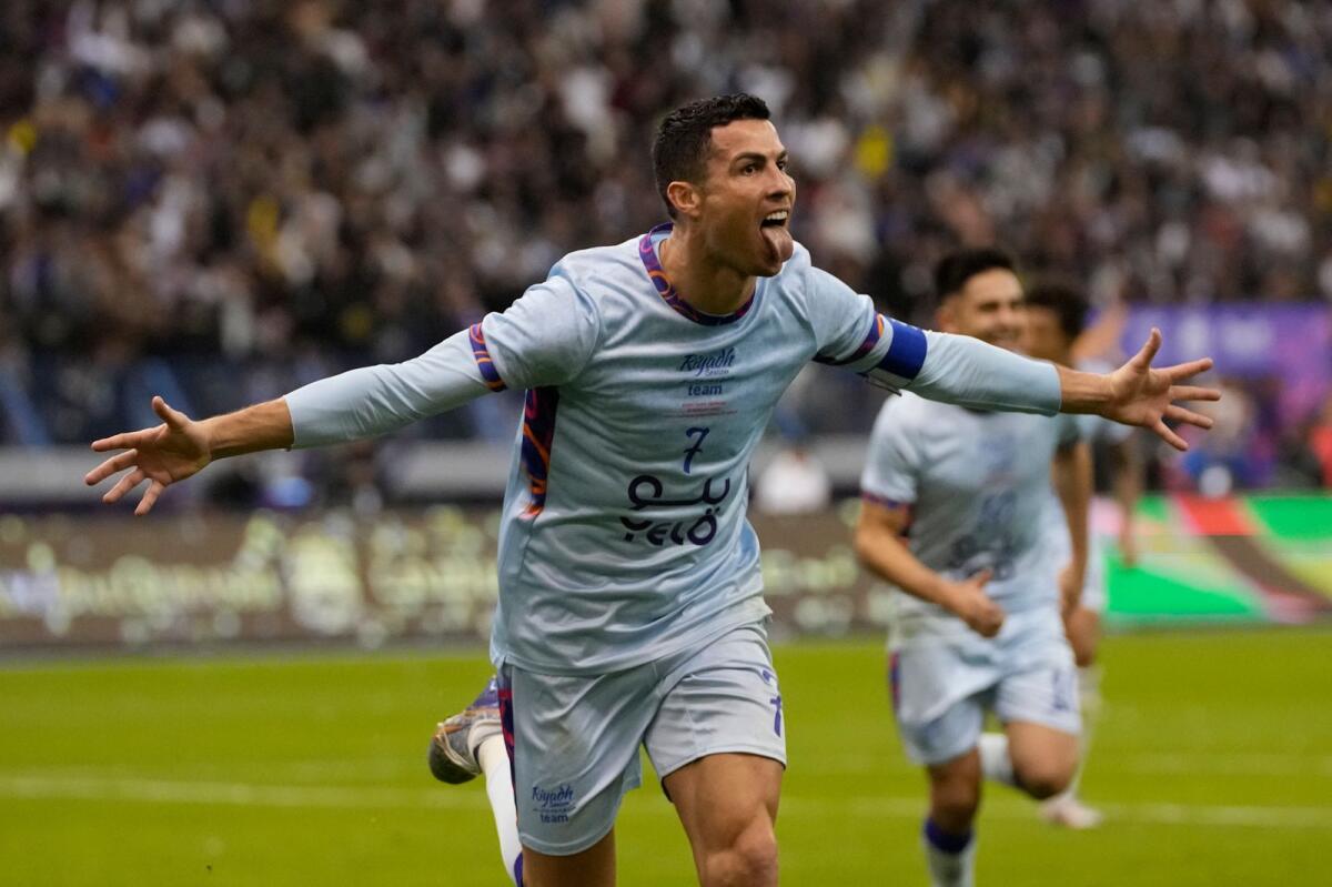 Cristiano Ronaldo celebrates after scoring his side's second goal against PSG. — AP