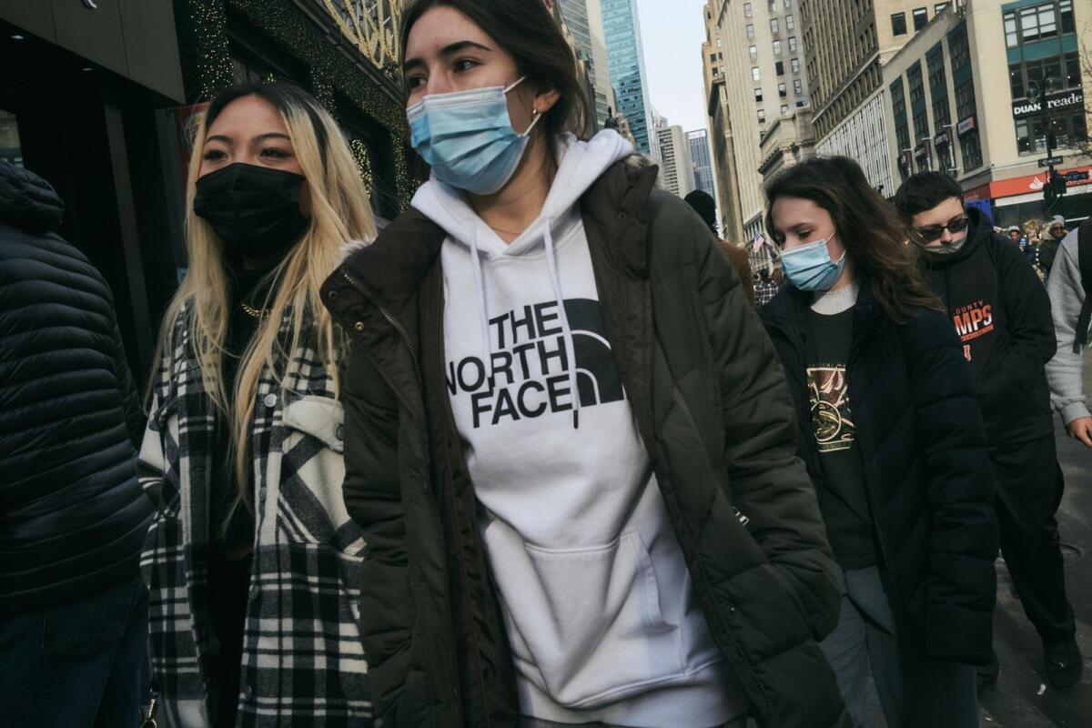 FILE — People wearing masks in Manhattan, on Tuesday, Dec. 21, 2021. (John Taggart/The New York Times)