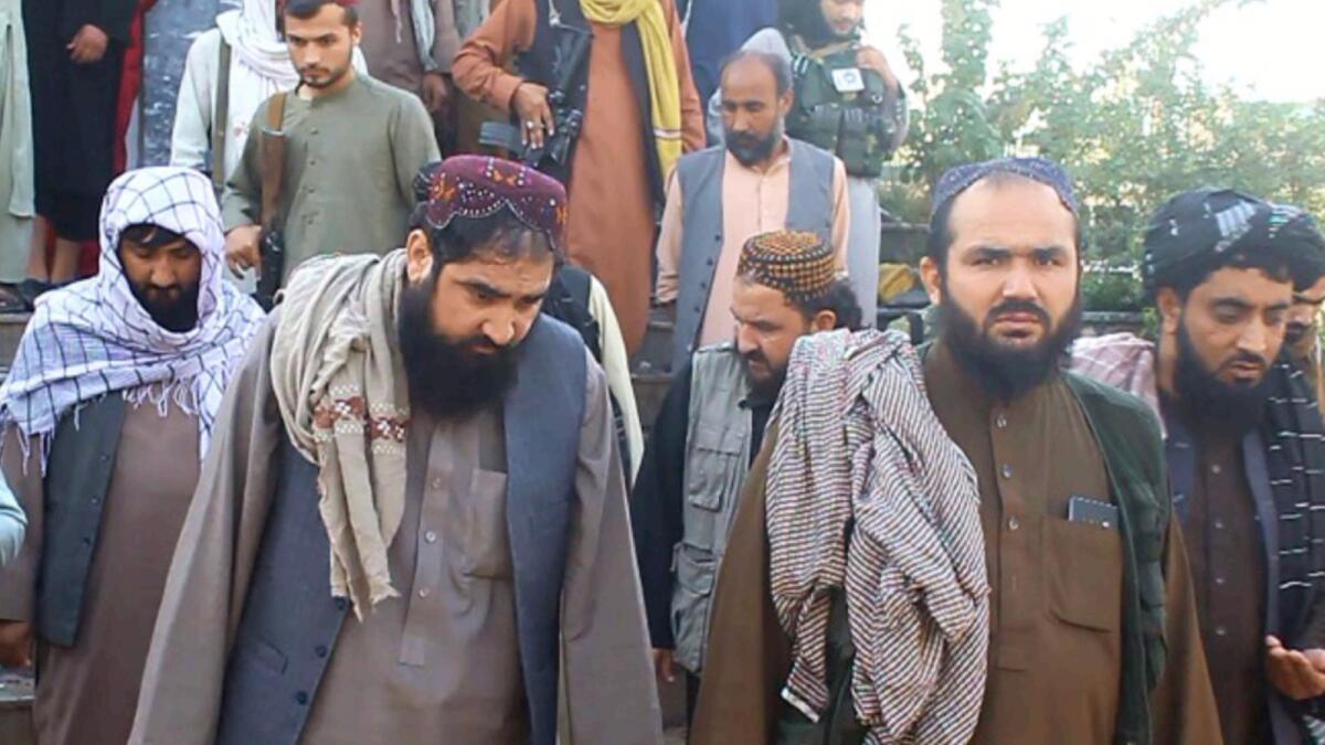 Taliban officials outside a mosque after a suicide bomb attack in Kunduz. — AFP