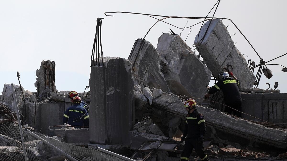 Firefighters search for trapped people at a partly demolished structure following an earthquake, at the port of Piraeus, near Athens, Greece.- Reuters 