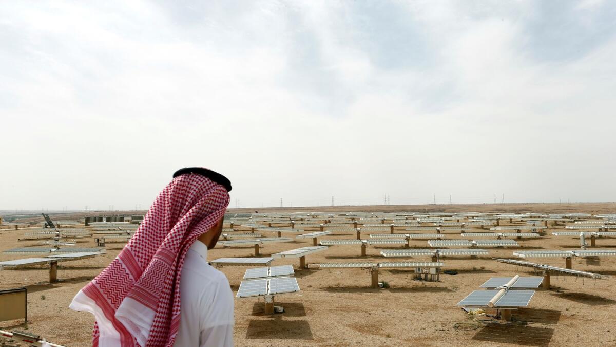 A Saudi man looks at a solar plant in Uyayna, north of Riyadh, Saudi Arabia. — Reuters