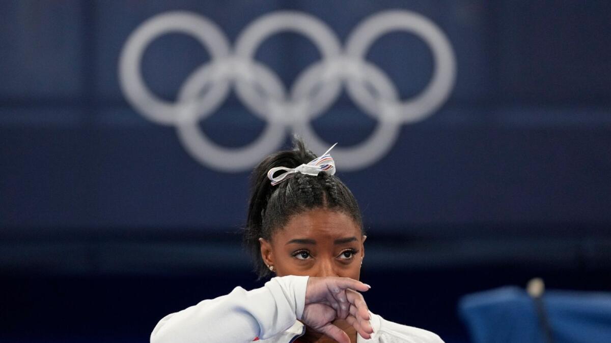 Gymnastics superstar Simone Biles reacts after withdrawing from the final at the Tokyo Olympics on Tuesday. (AP)