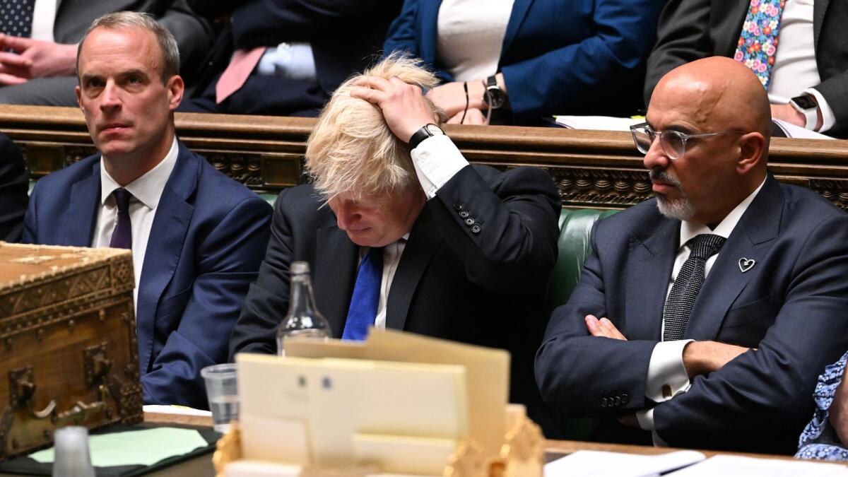 Britain's Prime Minister Boris Johnson (C) flanked by Britain's Justice Secretary and deputy Prime Minister Dominic Raab (L) and Britain's new Chancellor of the Exchequer Nadhim Zahawi (R) during prime minister's questions in the House of Commons in London on July 6, 2022. Photo: AFP