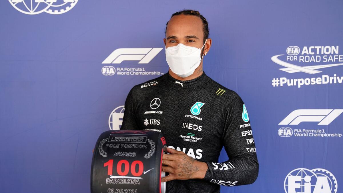 Mercedes driver Lewis Hamilton of Britain poses after he clocked the fastest time in the qualifying for the Spanish Formula One Grand Prix at the Barcelona Catalunya racetrack in Montmelo. — AP