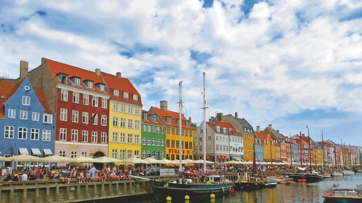 Pastel-coloured houses line the waterfront in Nyhavn, a popular tourist hangout in Copenhagen