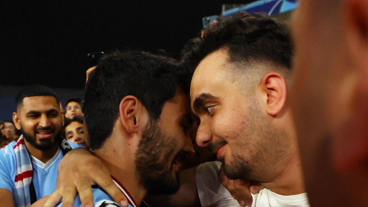 Manchester City's Ilkay Gundogan celebrates with fans after winning the Champions League.