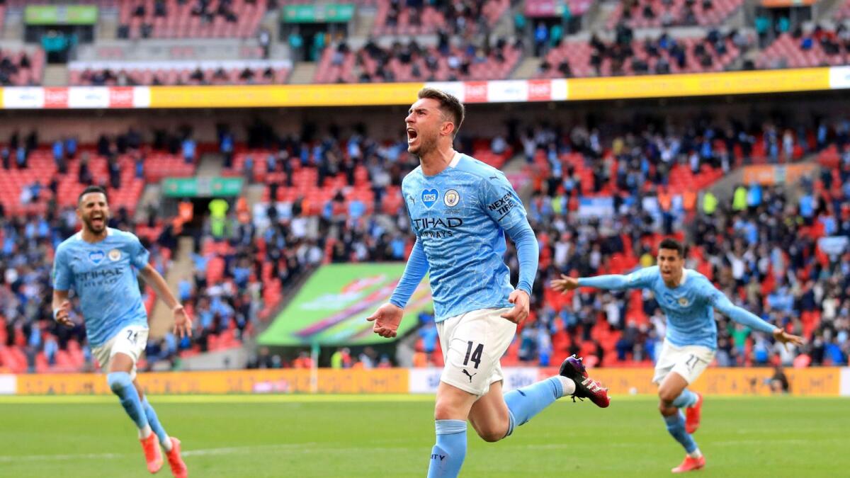 Manchester City's Aymeric Laporte celebrates scoring a goal against Tottenham Hotspur. — AP