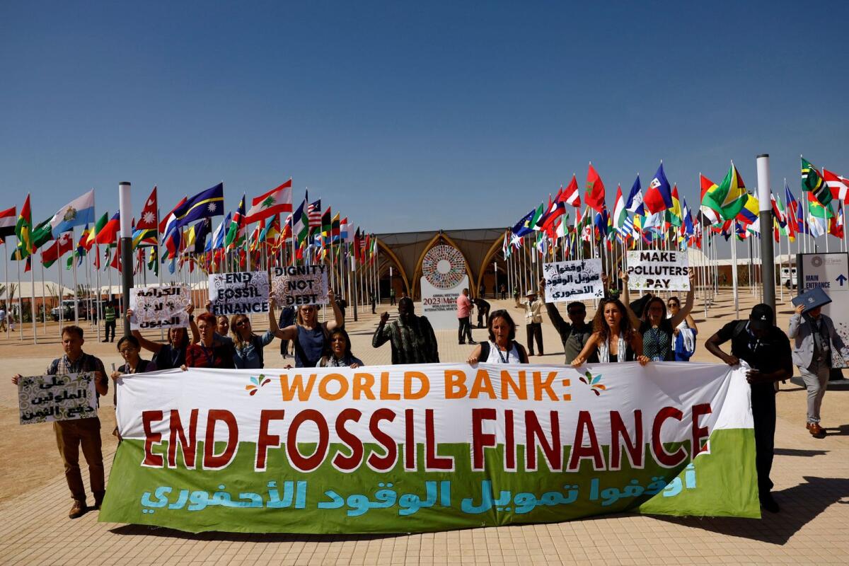 Climate activists protest demanding that the World Bank stop fossil fuel financing on the first day of the annual meeting of the International Monetary Fund and the World Bank, in Marrakech, Morocco,  October 9, 2023. — Reuters