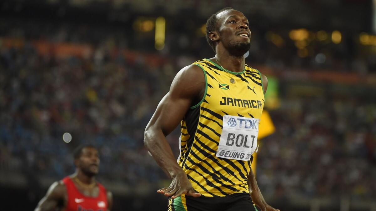 Jamaica's Usain Bolt celebrates after winning the final of the men's 200 metres athletics event at the 2015 IAAF World Championships at the 'Bird's Nest' National Stadium in Beijing on August 27, 2015.  AFP PHOTO / OLIVIER MORIN