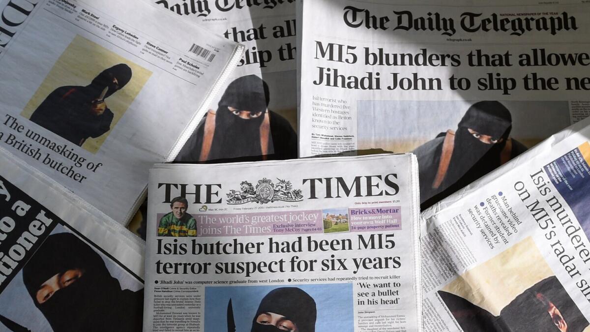 An arrangement of British daily newspapers photographed in London shows the front-page headlines and stories regarding the identification of Jihadi John.