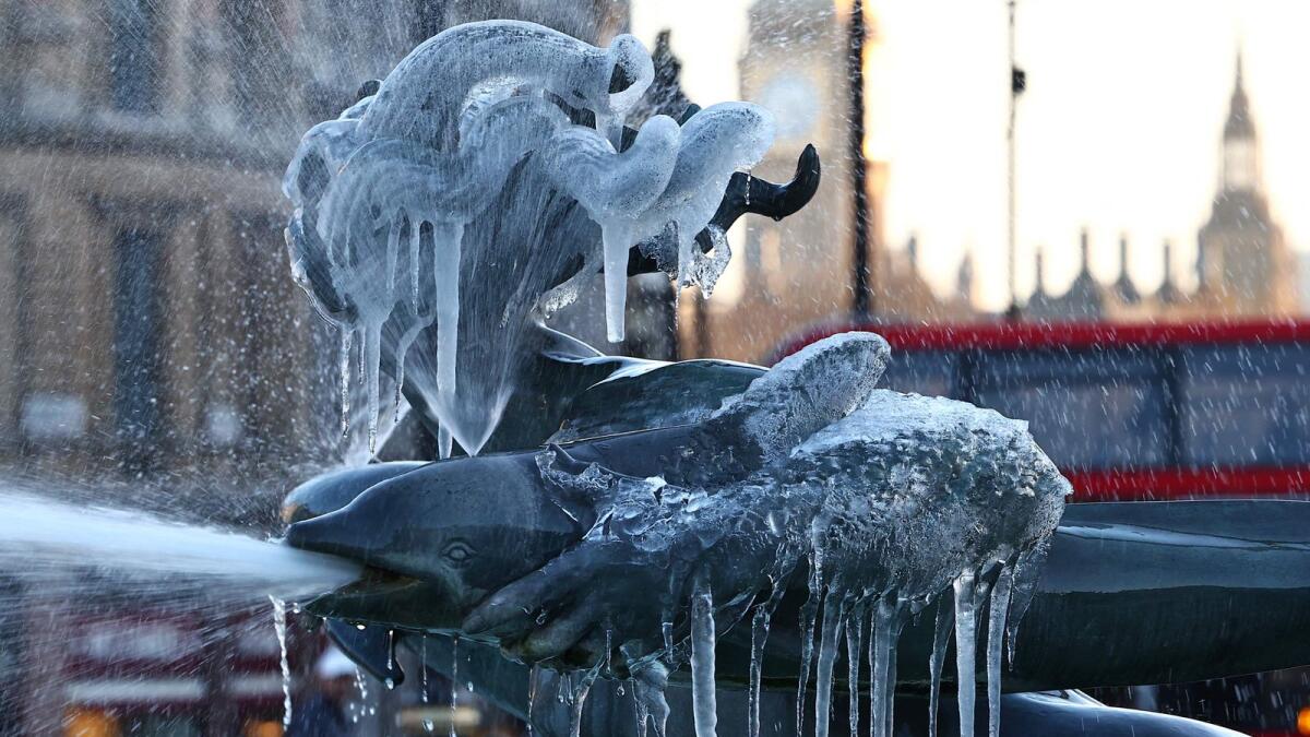 Icicles hang from a frozen fountain sculpture in Trafalgar Square in central London. — AFP