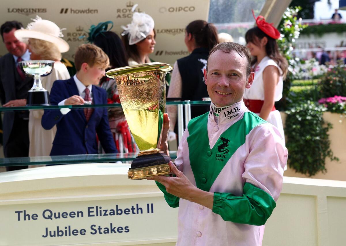 Jamie Spencer celebrates with the trophy after winning the Queen Elizabeth II Jubilee Stakes riding Khaadem. — Reuters
