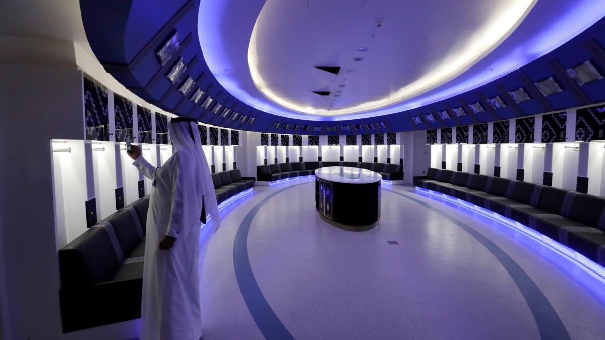 A Qatari official take picture of the teams dressing room of Al Bayt Stadium, one of the 2022 World Cup stadiums, in Al Khor,. — AP