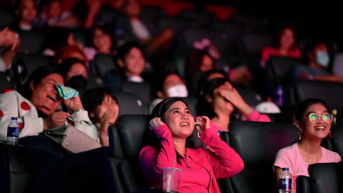 Moviegoers react as they watch the 'Barbie' film at the SM North Edsa in Quezon City on Wednesday. — AFP