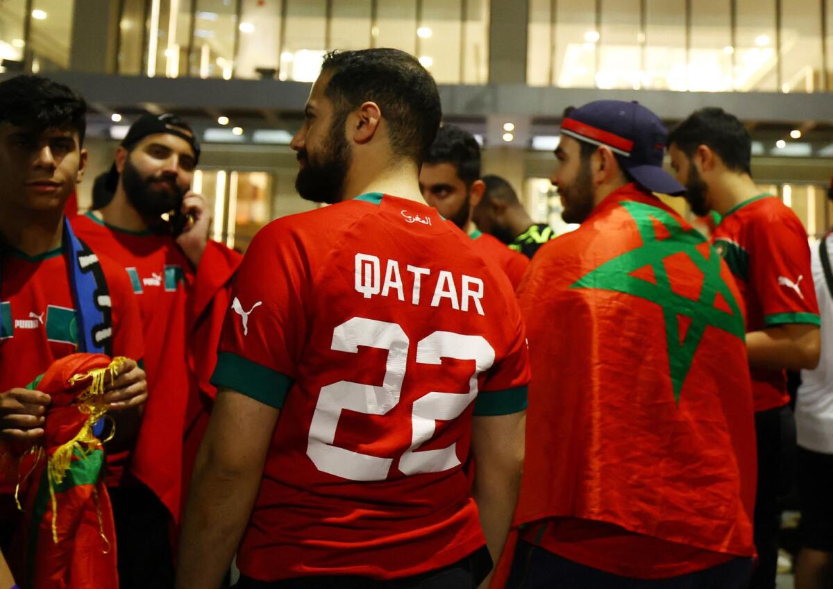 Morocco fans wait for the team bus to arrive as they celebrate progressing to the quarter finals after beating Spain. Reuters