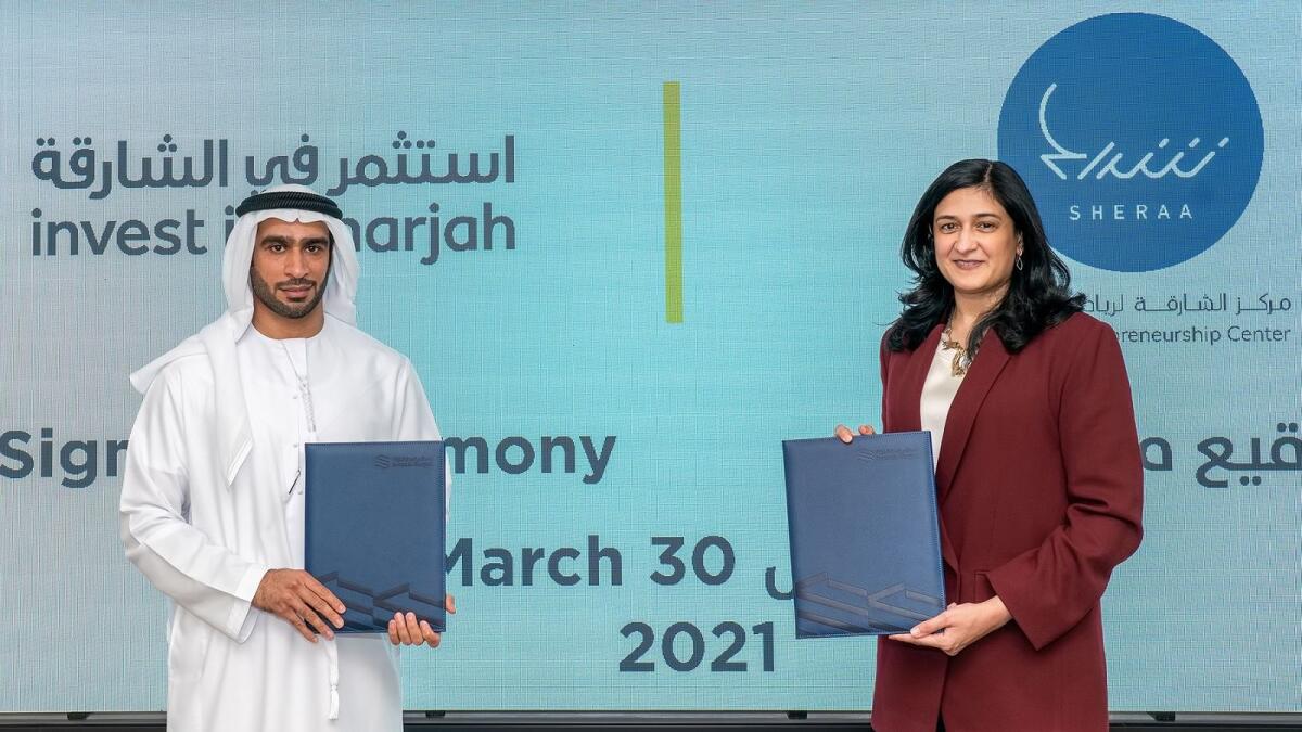 Najla Al Midfa and Mohamed Juma Al Musharrkh during the signing ceremony held at Saeed Centre in Sharjah on Tuesday. — Supplied photo