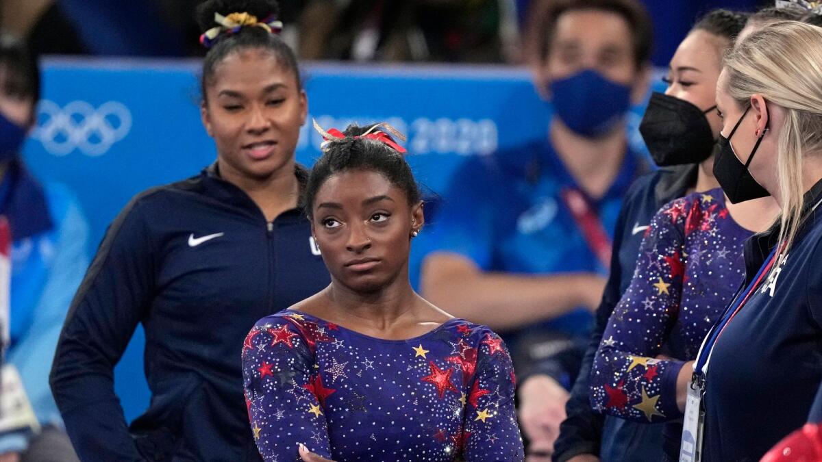 Simone Biles waits for her score after performing on the balance beam during the women's artistic gymnastic qualifications. — AP