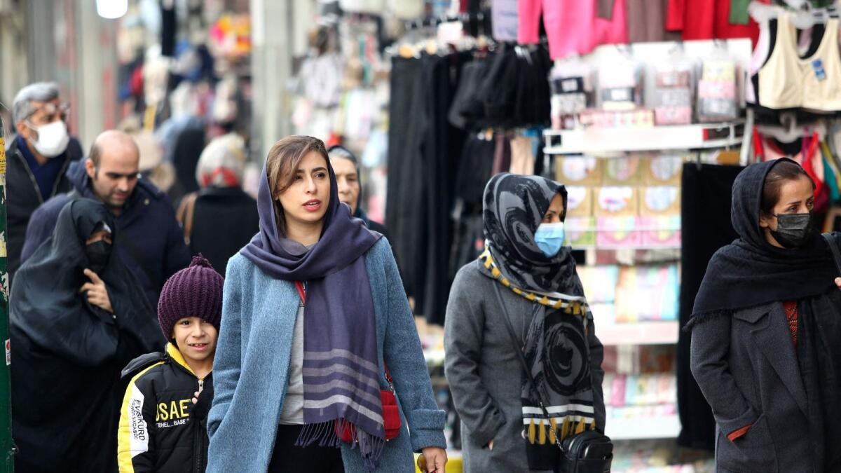 Iranian shoppers walk through the bazaar of Tajrish in northern Tehran on January 25. — AFP file