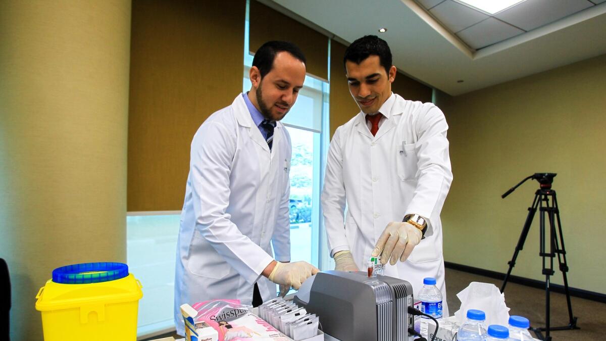Lab techs testing blood samples of staffs of Ministry of Health &amp; Prevention, Dubai as part of a campaign to mark the World Health Day on April 7, 2016