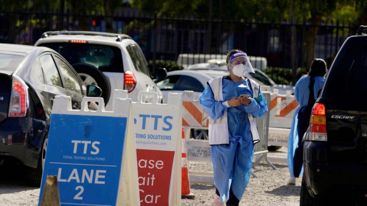 Workers wear protective equipment at a Covid-19 testing site in the Boyle Heights section of Los Angeles. — AP