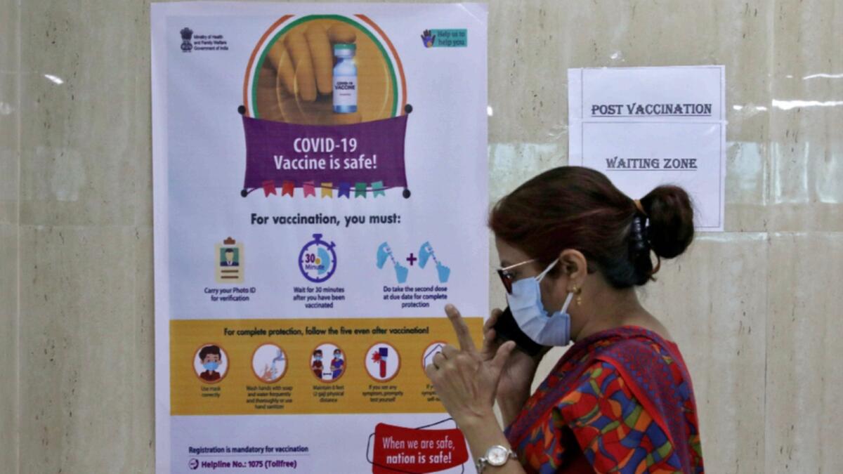 A woman speaks inside a waiting zone area at a health clinic where Covid-19 vaccination is being given to healthcare workers in Kolkata. — Reuters