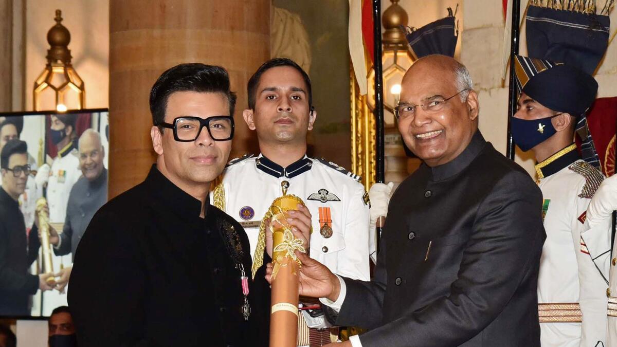 India's President Ram Nath Kovind presents the Padma Shri award to Karan Johar for Art, in New Delhi on Monday. (Photo/ANI)