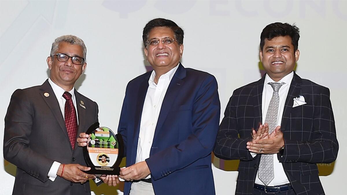 Piyush Goyal receiving a memento from Sunder Nurani in Dubai on Sunday. Anurag Chaturvedi was also present on the occasion. — Supplied photo