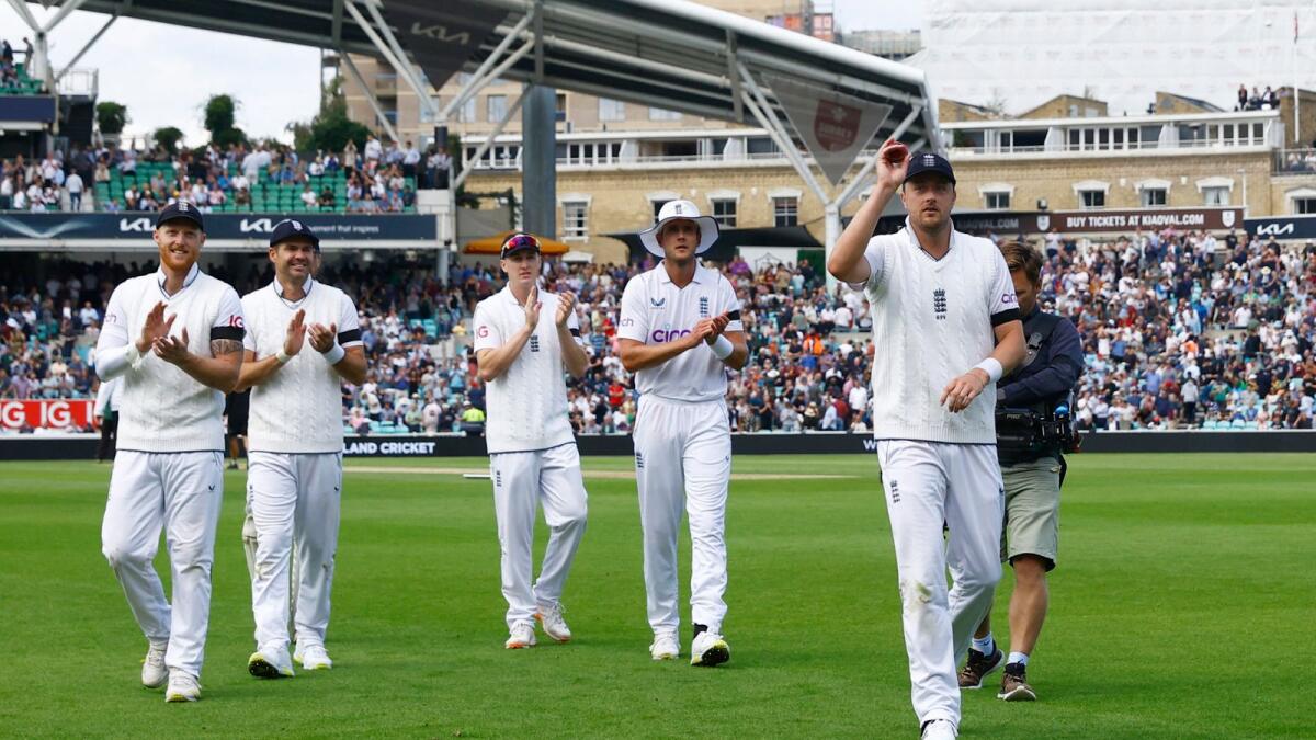 England's Ollie Robinson walks off holding the ball after taking a five wicket haul in South Africa first innings as teammates applaud. — Reuters
