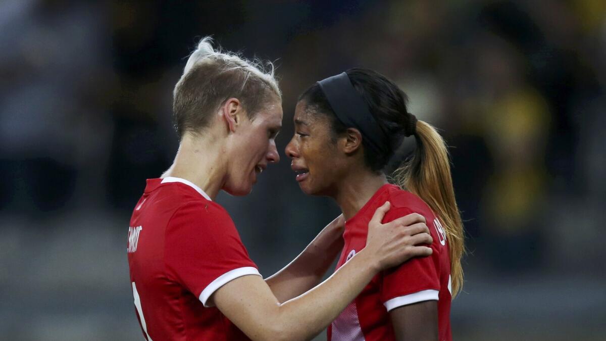 Sophie Schmidt and Ashley Lawrence of Canada react after losing to Germany in the women's soccer semifinal. Reuters