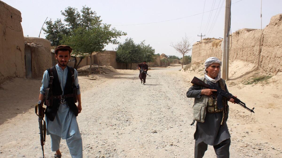 Armed Afghan militias patrol on the outskirts of Takhar province on Sunday.