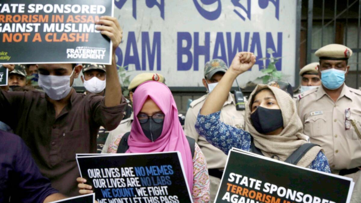 Students shout slogans outside Assam Bhawan in New Delhi during a protest against the killing of protesters during an eviction drive in Darrang, Assam. — ANI