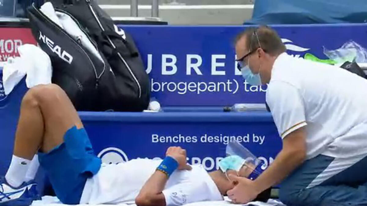 Novak Djokovic receives treatment to his neck during the semifinals against Spain's Roberto Bautista Agut. -- Twitter
