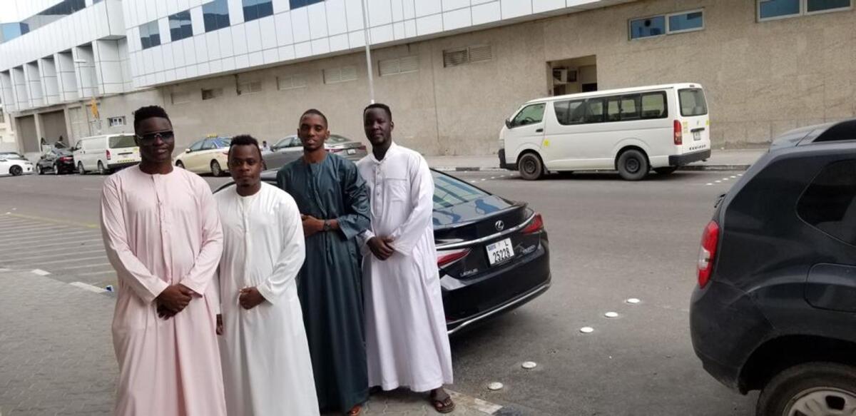Joshua Muwonge, with his friends Fahad Ssengooba, Asuman, Adam, Raymond outside a mosque in Deira.