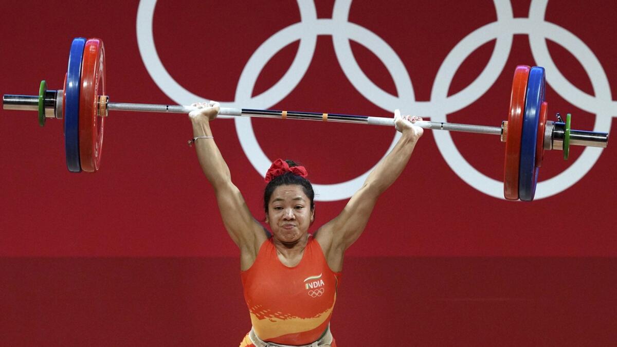 India's Mirabai Chanu during an attempt in the women's 49 Kg category weightlifting event. — PTI