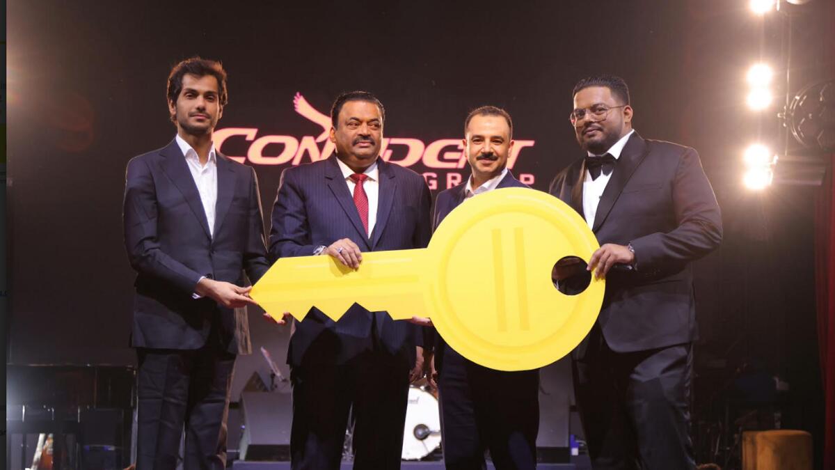 Dr. Roy. C. J, Rohit Roy, and Engr. Walid Salah handing over the key to the first owner. — Supplied photo