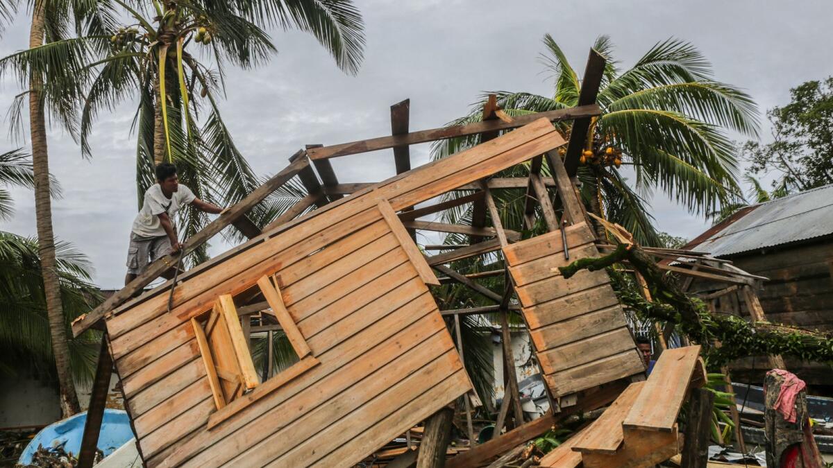 Men fix a small house in 'El Muelle' Neighbourhood in Bilwi, Nicaragua on November 5, 2020, after the passage of hurricane Eta.