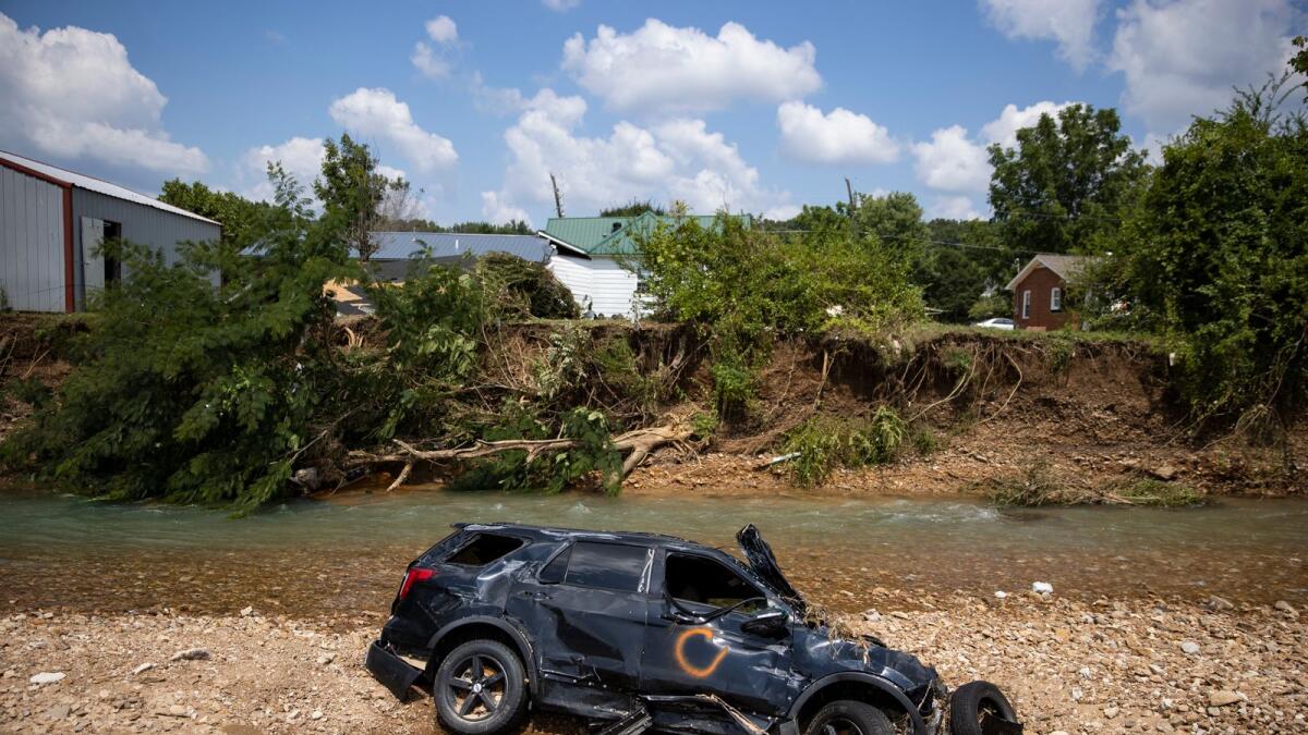 A vehicle destroyed by flooding sits in Trace Creek in Tennessee. Photo: AFP