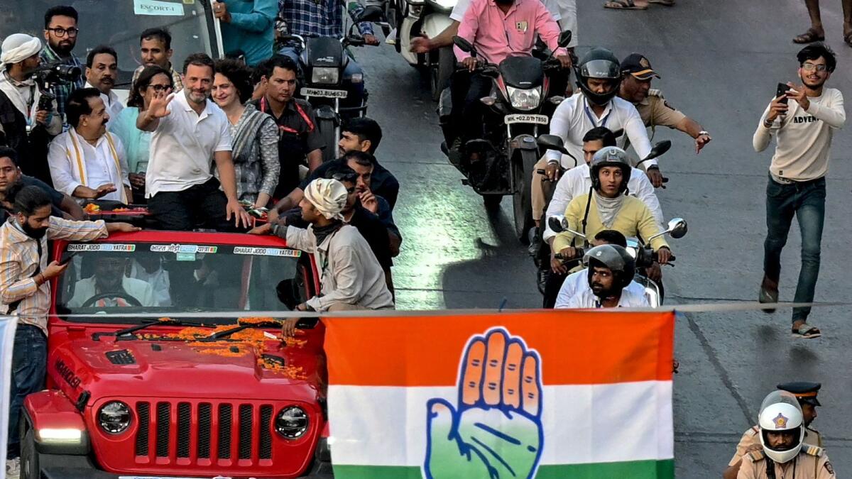 Congress leaders Rahul Gandhi and Priyanka Gandhi Vadra gesture during a roadshow in Mumbai. — AFP file