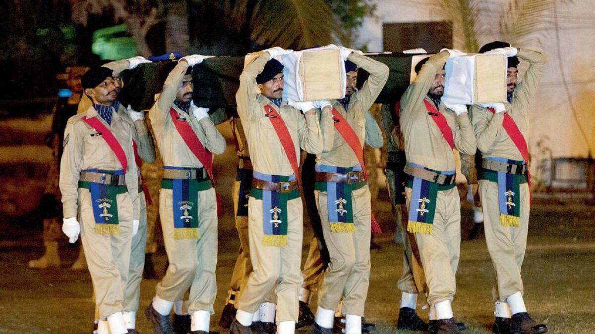 Soldiers carry the coffins of soldiers who lost their lives in a terrorist attack in Karachi. 